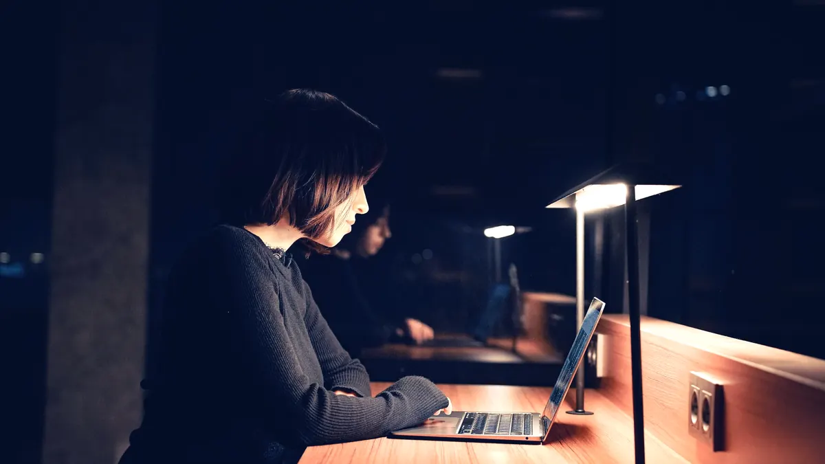 A buyer researching options on a laptop in the evening