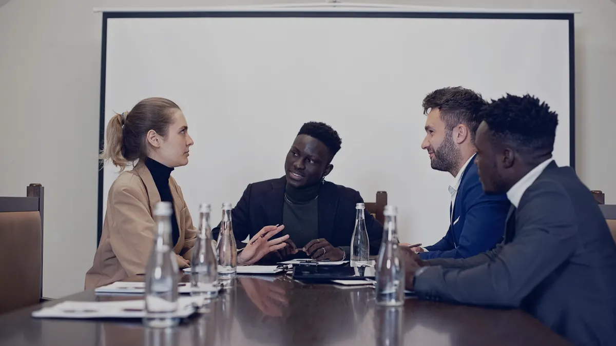 A sales meeting around a boardroom table