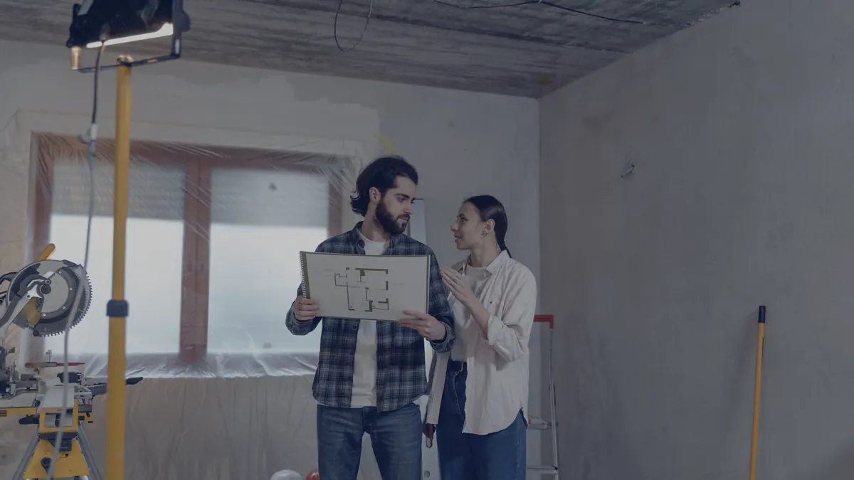 A couple reviewing renovation plans in their home